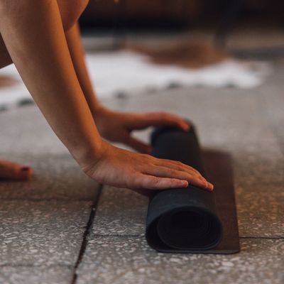 Close-up of hands gripping a yoga mat.