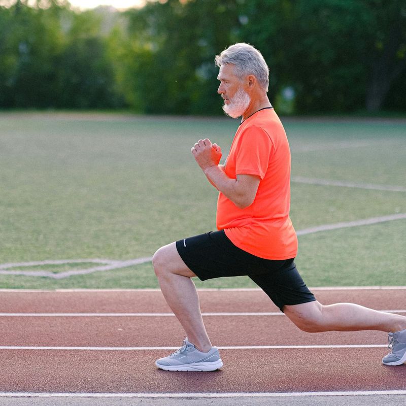 Man in a deep lunge position, focusing on balance.