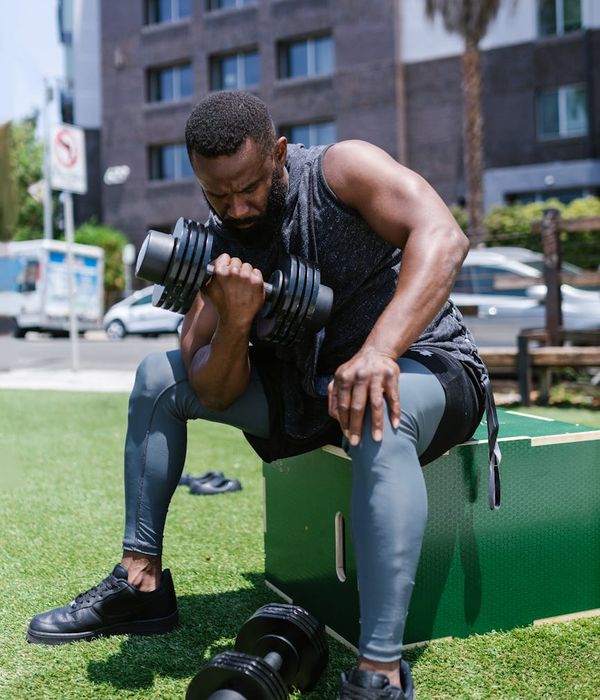 Man performing a controlled bodyweight exercise in a minimalist gym.